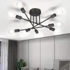 A black, multi-arm ceiling light fixture with exposed bulbs is shown against a white ceiling. Produktbild-Vorschau