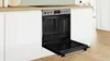 A built-in oven with its door open, set into a modern kitchen counter with white cabinets. Produktbild-Vorschau