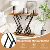 A console table with a wooden top and black metal legs, decorated with a lamp, books, and a plant. Podgląd zdjęcia produktu