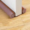 A close-up view of a door draft stopper on a wooden floor. Náhled obrázku produktu