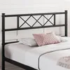 A close-up view of a black metal bed frame headboard with a diamond pattern, placed on a bed with white linens and pillows. Podgląd zdjęcia produktu