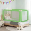 A child's bed with a green bed rail installed, in a bedroom setting with decorative flags on the wall and stuffed animals on the floor. Anteprima dell’immagine prodotto