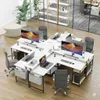 A modern office space with multiple L-shaped desks arranged in a cluster, equipped with computers and office chairs. Anteprima dell’immagine prodotto