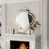 A decorative mirror above a fireplace with a fire burning. Produktbild-Vorschau