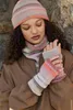 A woman wearing a knitted hat, scarf, and fingerless gloves. Produktbild-Vorschau