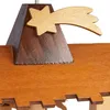 A close-up view of a wooden Christmas pyramid decoration, focusing on the roof detail and a star ornament. Náhled obrázku produktu