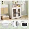 A bathroom or laundry room setting with a white cabinet, a woven basket, and a vanity. Anteprima dell’immagine prodotto