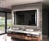 A modern bathroom vanity with a large illuminated mirror, sinks, and wooden cabinetry. Produktbild-Vorschau