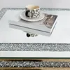 A close-up of a coffee cup and saucer on top of a book, placed on a mirrored surface with a crushed diamond inlay. Anteprima dell’immagine prodotto