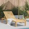 A wooden sun lounger is placed on a patio next to a swimming pool, with a wooden fence and greenery in the background. Náhľad obrázku produktu