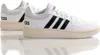 A pair of white Adidas Hoops 3.0 sneakers with black stripes and a cream-colored sole, shown from a side-back angle with reflections. Anteprima dell’immagine prodotto