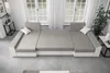 A U-shaped couch is shown in a room with large windows and white curtains. Náhled obrázku produktu