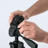 Hands adjusting a tripod head. Anteprima dell’immagine prodotto