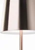 A close-up view of the bottom part of a copper-colored table lamp with a white interior shade. Podgląd zdjęcia produktu
