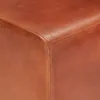 A close-up view of the corner of a brown leather ottoman. Voir les images du produit