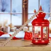 A wooden advent calendar staircase leading to a red lantern with candles inside, set against a snowy window background. Produktbild-Vorschau