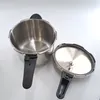 A stainless steel pressure cooker with its lid off, placed on a white surface. Podgląd zdjęcia produktu