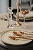 A table setting with plates, cutlery, and a wine glass. Náhľad obrázku produktu