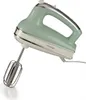 A vintage-style green hand mixer is shown against a white background. Voir les images du produit