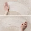 Two close-up shots of hands wiping a surface, creating a curved streak. Produktbild-Vorschau