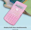 A pink scientific calculator is placed on top of an open book, with a blue background. Náhled obrázku produktu