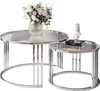 A set of two modern, round coffee tables with glass tops and chrome frames, one larger than the other, displayed with decorative items. Náhled obrázku produktu