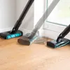 A vacuum cleaner head is shown in motion on a wooden floor, near a wall and window. Náhled obrázku produktu