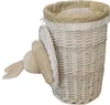 A white wicker laundry basket with a polka dot fabric lining and a plush bunny toy attached to the side. Produktbild-Vorschau