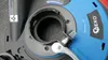 Close-up of a blue and black power tool accessory, likely a dust collection shroud for an angle grinder. Náhled obrázku produktu