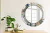 A round mirror with an abstract stained glass design is displayed on a wooden dresser next to a potted plant and desk accessories. Produktbild-Vorschau