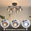 A collage showing a black ceiling light with five glass shades, and close-ups of the light bulbs. Produktbild-Vorschau
