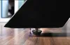 Close-up of a table leg resting on a wooden floor, showing an adjustable foot. Produktbild-Vorschau