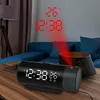 A digital alarm clock projecting the time and temperature onto a wall in a dimly lit room. Podgląd zdjęcia produktu