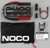 A NOCO Boost GB150 jump starter kit is laid out on a light gray background, with its accessories and storage bag. Produktbild-Vorschau