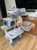 A cat is playing on a cat tree in a living room. Náhled obrázku produktu