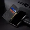 A black leather wallet-style phone case is open, showing slots for cards and cash, with a black smartphone placed inside. A smartwatch is visible in the background. Produktbild-Vorschau
