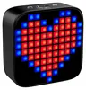 A black Bluetooth speaker with a pixelated heart display made of red and blue lights. Voir les images du produit