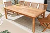 A wooden garden table and chairs set on a wooden deck. Produktbild-Vorschau