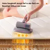 A person is using a handheld mattress cleaner on a mattress. The image shows a cutaway view of the mattress layers with heat waves indicating the cleaning process. Produktbild-Vorschau