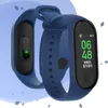 Two blue fitness trackers are displayed against a light blue background with abstract shapes. Produktbild-Vorschau