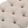 Close-up of a tufted beige fabric surface with button accents. Produktbild-Vorschau