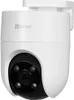 A white security camera with a black lens and four infrared lights is shown against a white background. Produktbild-Vorschau