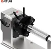 A close-up view of a rotary roller attachment for a laser engraver, holding a cylindrical object. Náhled obrázku produktu