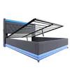 A grey upholstered bed frame with the mattress support mechanism lifted, revealing storage space underneath. Blue LED lighting is visible along the base and headboard. Náhľad obrázku produktu