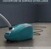 A teal and silver vacuum cleaner is shown in a room with a dark gray wall and a light gray floor. The vacuum cleaner's cord is extended across the floor, demonstrating its reach. Produktbild-Vorschau