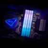 A close-up view of computer RAM modules and a CPU cooler with RGB lighting. Produktbild-Vorschau