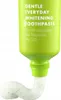 A close-up of a green toothpaste tube with toothpaste squeezed out. Anteprima dell’immagine prodotto