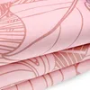 Close-up view of folded pink fabric with a pattern. Podgląd zdjęcia produktu