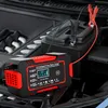 A car battery charger is connected to a car battery in an engine bay. Podgląd zdjęcia produktu