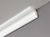 A close-up view of white crown molding installed at the corner of a room where the ceiling meets the wall. Produktbild-Vorschau